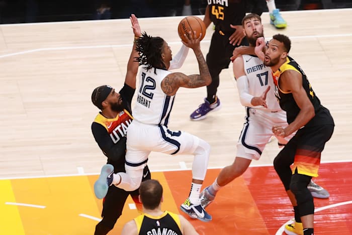 Ja Morant (12) shoots over Mike Conley (10)